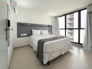 a bedroom with a large bed and a large window at Hotel Kazullo in Maceió +28 photos