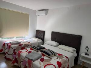 a bedroom with two beds and a window at Seven Hotel - Juana Koslay San Luis in Juana Koslay  +42 photos