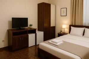 a bedroom with a bed and a flat screen tv at Heaven Boutique in Pucioasa