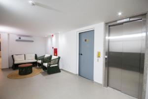 a living room with a couch and a door at Hotel Kazullo in Maceió
