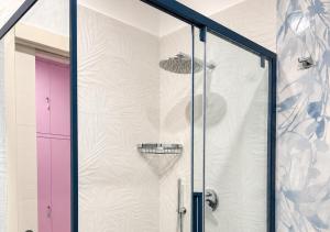 a shower with a glass door with a basketball at L'Abbraccio in Tivoli +26 photos