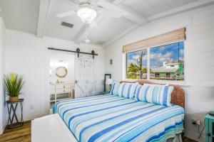 a bedroom with a bed and a window at CJ286FLR LUX-Parrotfish Point in Cudjoe Key