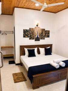 a bedroom with a large bed in a room at Ceylon Beach haven Uppuveli in Trincomalee