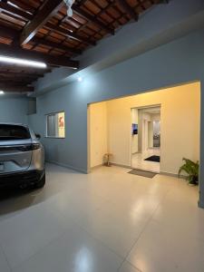 a garage with a car parked in it at Casa Nova, 2 quartos, 1 Ar-Cond, 1 Banheiro, Garagem 4,30m in Montes Claros