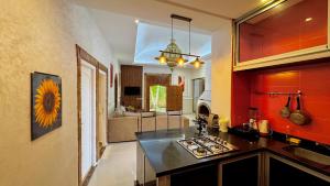 a kitchen with a counter top and a living room at Villa familiale avec piscine privée sans vis à vis in Oulad Raho