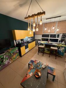 a living room with a table and a kitchen at Byout Beirut G3 in Beirut