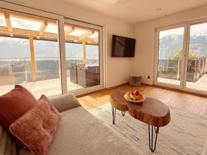a living room with a couch and a table with fruit on it at Apartment Bergliebe in Sellrain