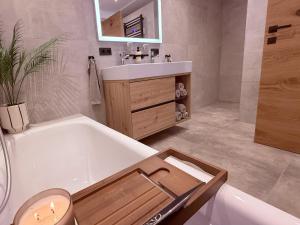 a bathroom with a bath tub and a sink at Apartment Bergliebe in Sellrain +52 photos
