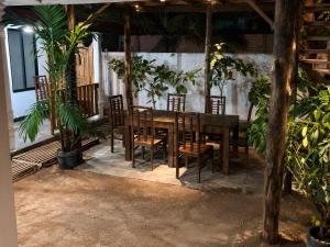 a table and chairs in a room with plants at Ceylon Beach haven Uppuveli in Trincomalee