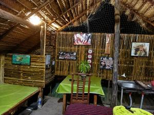 a room with a table and chairs in a hut at Ceylon Beach haven Uppuveli in Trincomalee