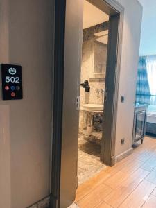 a door with a sign on it next to a bathroom at Peri Boutique Hotel Taksim in Istanbul