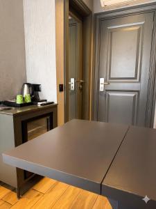 a large metal table in a room with a door at Peri Boutique Hotel Taksim in Istanbul +28 photos