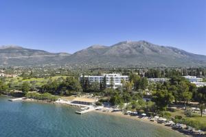 an aerial view of a resort with a beach and mountains at Paradise Resort Evia, a member of Radisson Individuals in Eretria