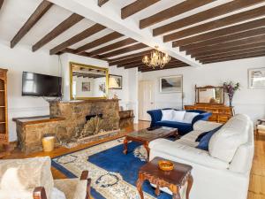 a living room with a couch and a fireplace at Conamara House in Ballyconneely