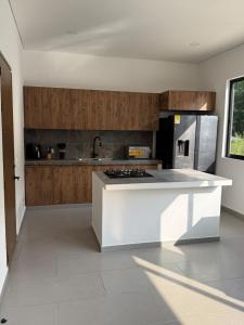 a kitchen with a white island in a room at Finca Exclusiva en Carmen de Apicalá in Carmen de Apicalá