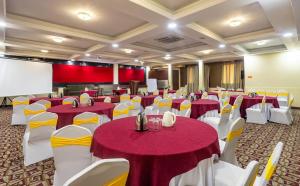 a conference room with red and white tables and chairs at Yellow Pagoda Hotel in Kathmandu