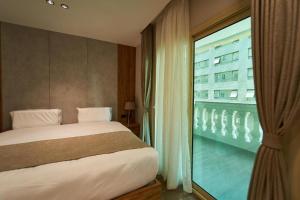 a bedroom with a bed and a large window at Gold's Pyramids Hotel in Cairo