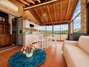 a living room with a couch and a table at Panoramic Sea View Apt 4 Close to the Beach With Pool in Baja Sardinia