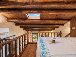 a bedroom with a bed in a room with wooden ceilings at Panoramic Sea View Apt 4 Close to the Beach With Pool in Baja Sardinia