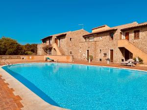 a large swimming pool in front of a building at Panoramic Sea View Apt 4 Close to the Beach With Pool in Baja Sardinia