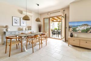 a kitchen and dining room with a table and chairs at Villa AmberBlue Kalathos in Kalathos