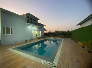 a swimming pool in the backyard of a house at GoBravo 48 - 2BHK Farm with Pool and Garden Sector 150 Noida in Greater Noida