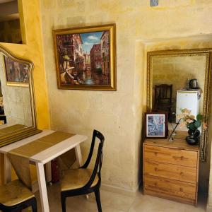 a dining room with a table and a painting on the wall at Santa Cesarea Sassi in Matera