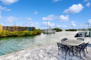 a table and chairs sitting on a dock next to a river at CK03 Fisherman's Retreat in Conch Key