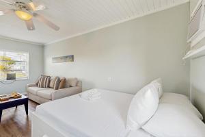 a white bedroom with a bed and a couch at CK03 Fisherman's Retreat in Conch Key