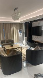 a living room with a couch and a table and chairs at Macdonald Residence in Lagos