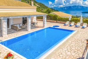 a swimming pool in the backyard of a house at Villa Morfeas in Nydri +14 photos