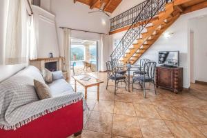 a living room with a couch and a table at Villa Morfeas in Nydri