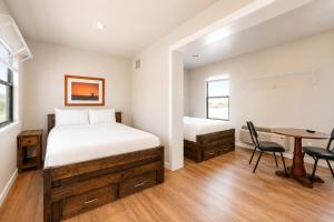 a bedroom with a bed and a desk and a table at The Resource Inn Big Lake in Big Lake