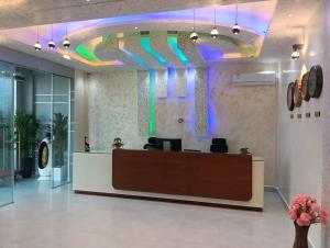a lobby with a reception desk with a colorful ceiling at The New Taiwan Hotel in Nyanhemwa +97 photos