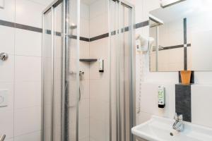 a bathroom with a shower and a sink at Gasthaus zur Krone in Weingarten (Karlsruhe) +45 photos