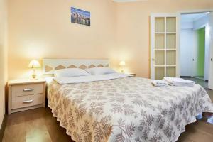 a bedroom with a large bed and two night stands at Home Hotel Apartments on Kontraktova Ploshcha in Kyiv