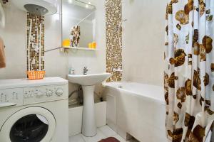 a bathroom with a washing machine and a sink at Home Hotel Apartments on Kontraktova Ploshcha in Kyiv