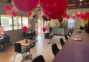 a room with tables and balloons in a restaurant at Travel Lodge in Middelburg +41 photos