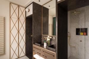 a bathroom with a sink and a mirror at Villa Costanza Boutique Hotel in Forte dei Marmi +47 photos