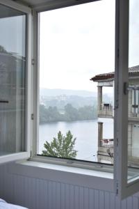 a window with a view of the water at Apartamentos Dulce Estrela in Tui