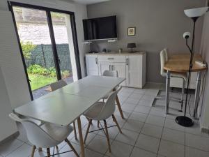 a dining room with a white table and chairs at Hortillonne in Amiens +28 photos