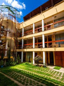 an apartment building with a lawn in front of it at Killaqente in Cusco