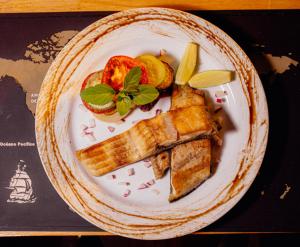 a plate of food with bread and fruit on it at casa de esteban in Puerto Iguazú