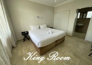a large bed in a room with a bathroom at Travel Lodge in Middelburg
