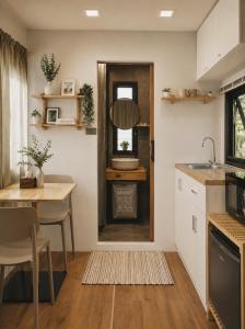 a kitchen and dining room with a table and a door at How Hide Homestay in Ban Tha Makham +30 photos