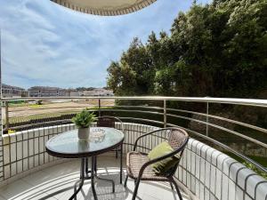 a patio with a table and chairs on a balcony at Apartamento Playa Azul - 5924 in Arnuero