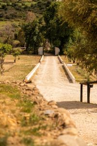 a dirt road with a bench in a park at Finca Santa Teresa, Casa Grande in Estepona