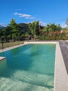 a swimming pool with blue water in a yard at Quinta da Lagoa - Gerês in Terras de Bouro