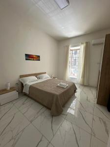 a bedroom with a bed and a large window at Binario104 in Naples