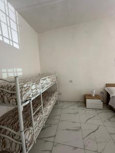 a room with two bunk beds and a tiled floor at Binario104 in Naples +1 photo